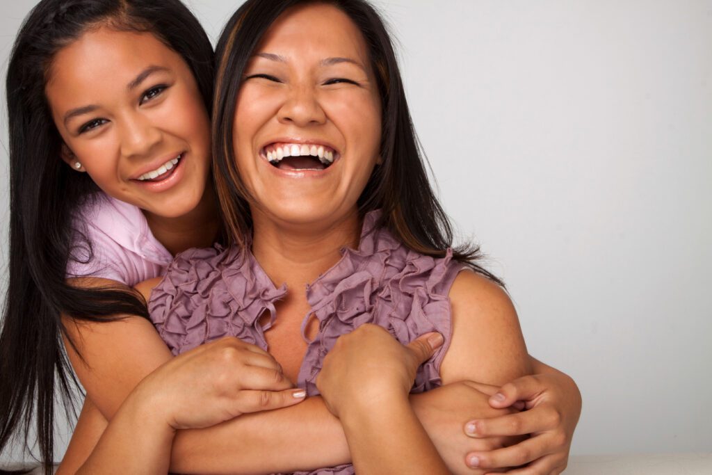 Asian mother and daughter smiling